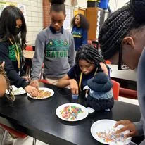 A student does a science activity with food. 