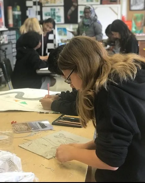 Photograph of a student drawing a picture.