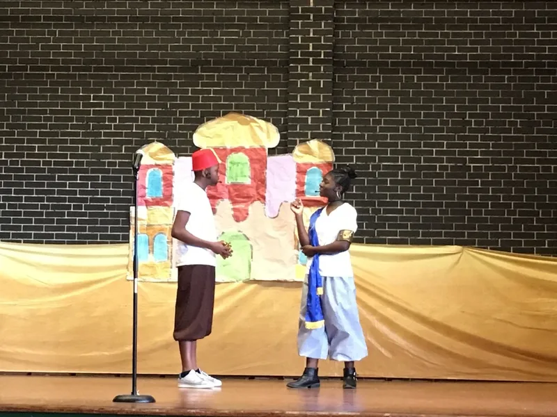A boy dressed as Aladdin is speaking to a student. 